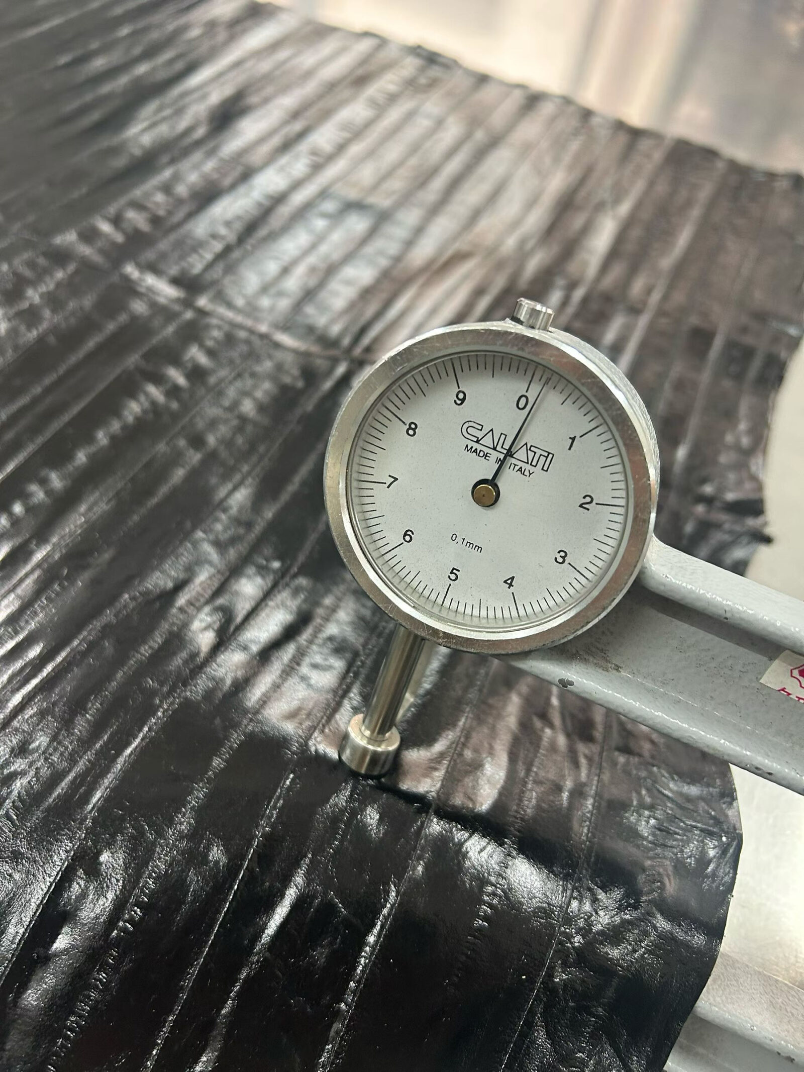 A thickness check on textured leather.